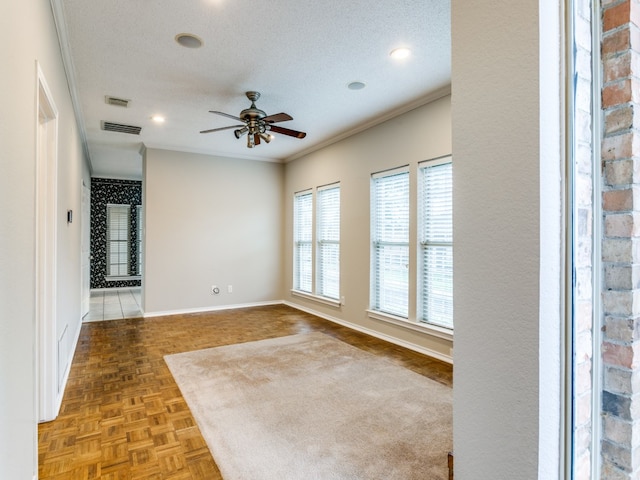 spare room with parquet floors, crown molding, a textured ceiling, and ceiling fan