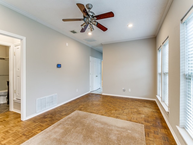 empty room with ceiling fan, parquet flooring, and ornamental molding