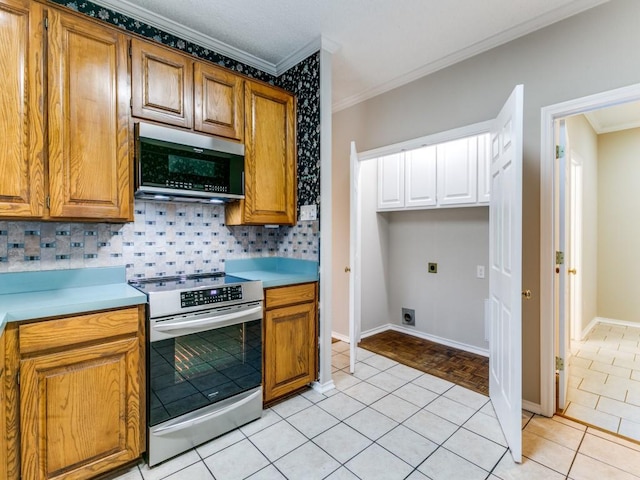 1216 Wooded Trl, Hurst, TX 76053 - kitchen featuring appliances with stainless steel finishes, ornamental molding, decorative backsplash, light countertops, and brown cabinetry