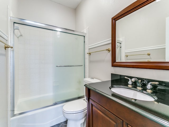 full bathroom with vanity, enclosed tub / shower combo, and toilet