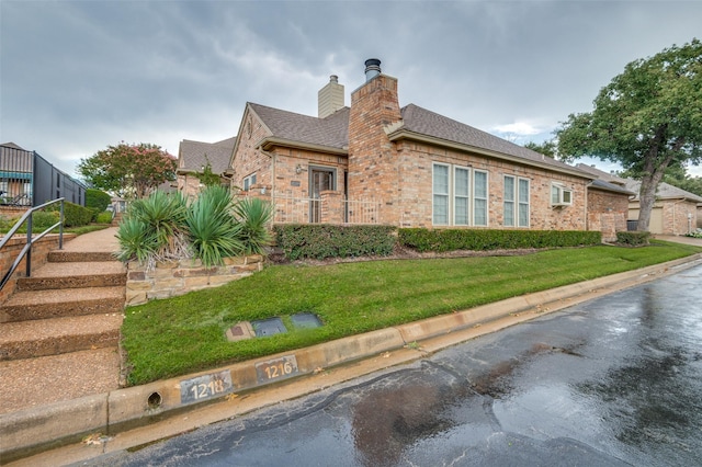 1216 Wooded Trl, Hurst, TX 76053 - view of property exterior with a chimney, brick siding, a shingled roof, and a lawn