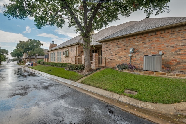 view of home's exterior featuring central AC and a lawn