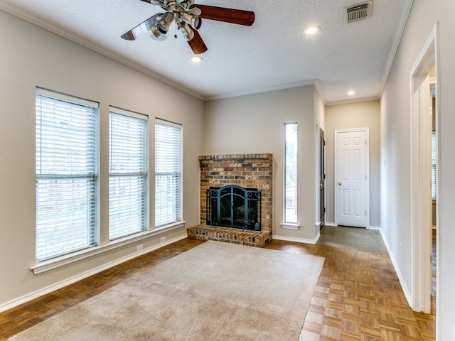 unfurnished living room featuring a textured ceiling, a fireplace, light parquet floors, and a wealth of natural light