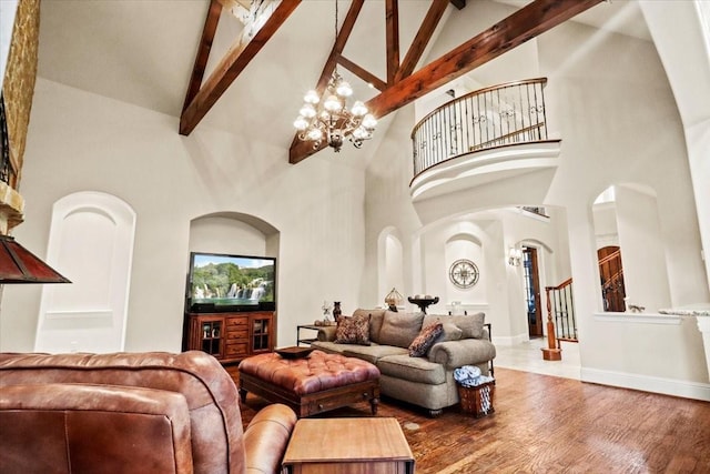 living room with a chandelier, hardwood / wood-style flooring, high vaulted ceiling, and beamed ceiling