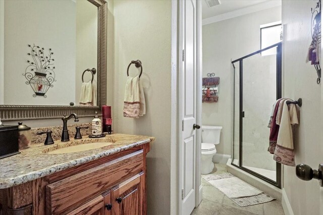 bathroom with toilet, vanity, an enclosed shower, and ornamental molding