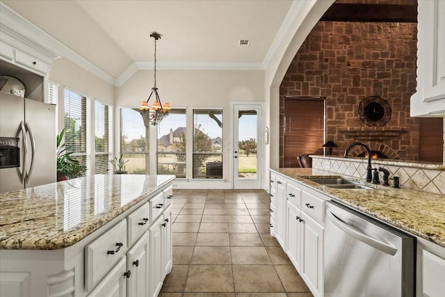 kitchen with white cabinets, decorative light fixtures, stainless steel appliances, and sink