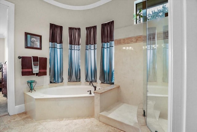 bathroom featuring separate shower and tub