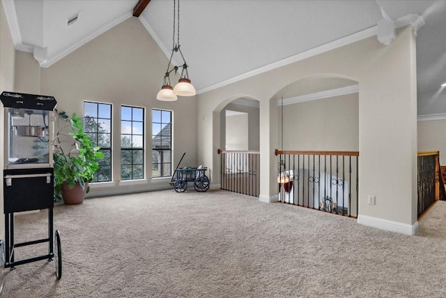 interior space with carpet, beamed ceiling, high vaulted ceiling, and ornamental molding