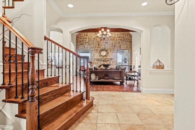 stairs featuring crown molding and a chandelier