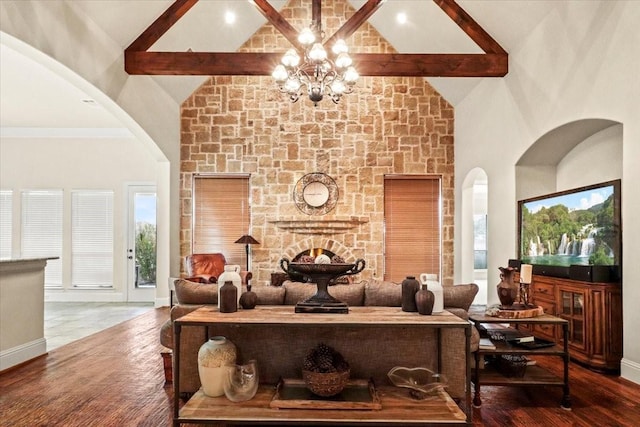 living room with beam ceiling, dark hardwood / wood-style flooring, high vaulted ceiling, and an inviting chandelier