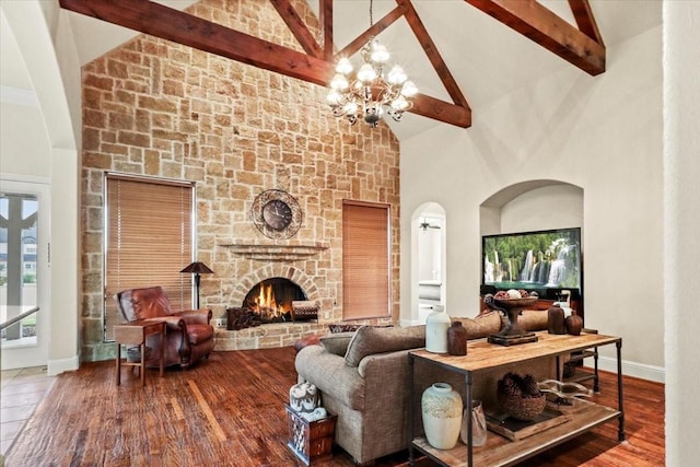 living room with a fireplace, wood-type flooring, high vaulted ceiling, a notable chandelier, and beamed ceiling