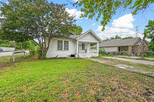 view of front of home with a front yard and a porch