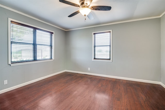 spare room featuring dark wood-type flooring, ceiling fan, and crown molding