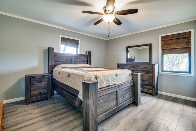 bedroom with crown molding, ceiling fan, and hardwood / wood-style flooring