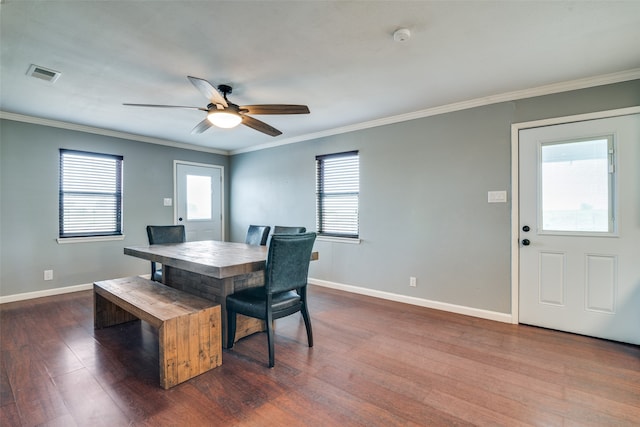 dining area with crown molding, ceiling fan, and dark hardwood / wood-style floors