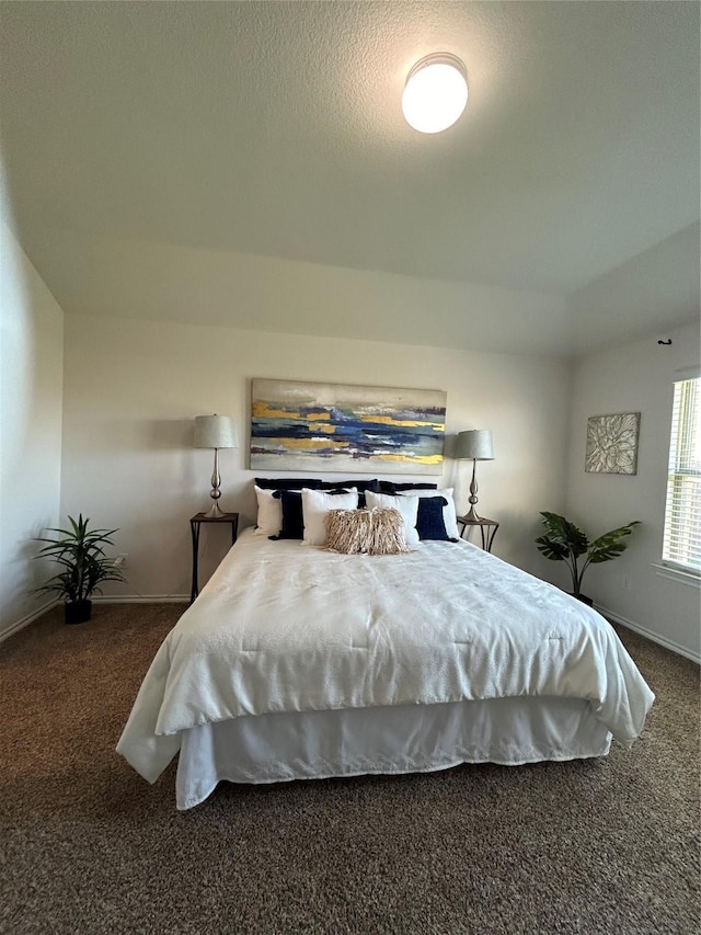 carpeted bedroom featuring a textured ceiling