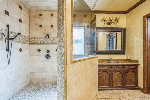 bathroom with tiled shower, vanity, and ornamental molding