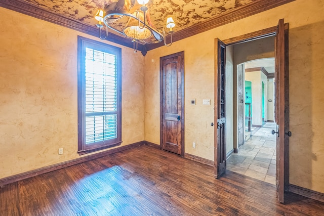 interior space with dark hardwood / wood-style floors, crown molding, and a notable chandelier