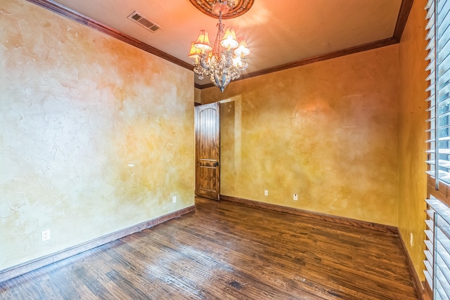 spare room with ornamental molding, wood-type flooring, and an inviting chandelier