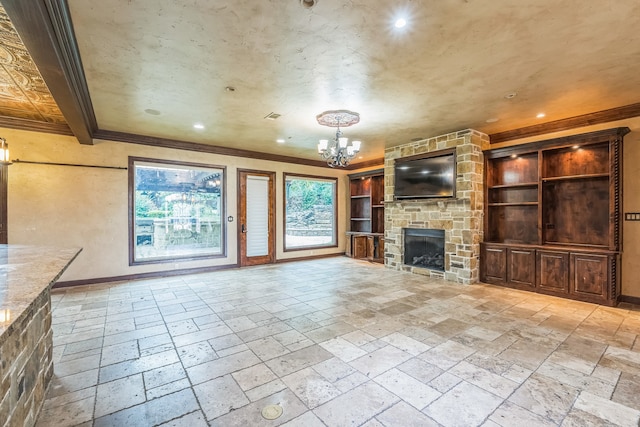 unfurnished living room with a fireplace, ornamental molding, and a notable chandelier