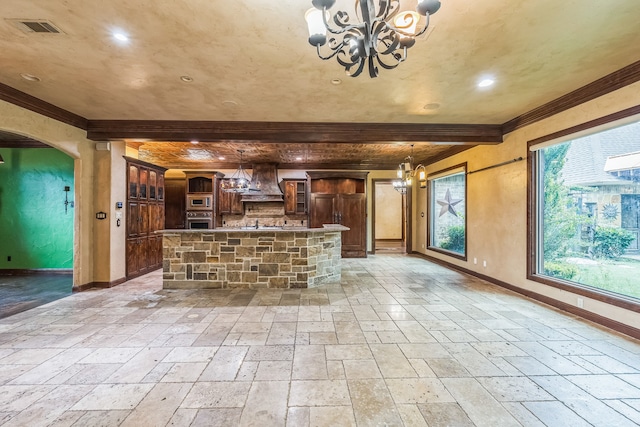 kitchen with a center island, custom exhaust hood, stainless steel appliances, a chandelier, and pendant lighting