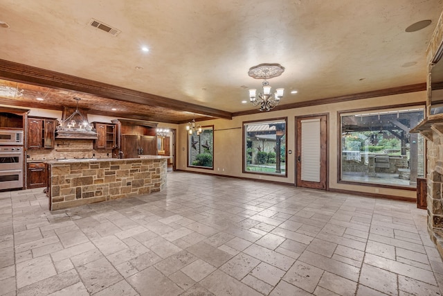 unfurnished living room featuring ornamental molding, a chandelier, and beam ceiling