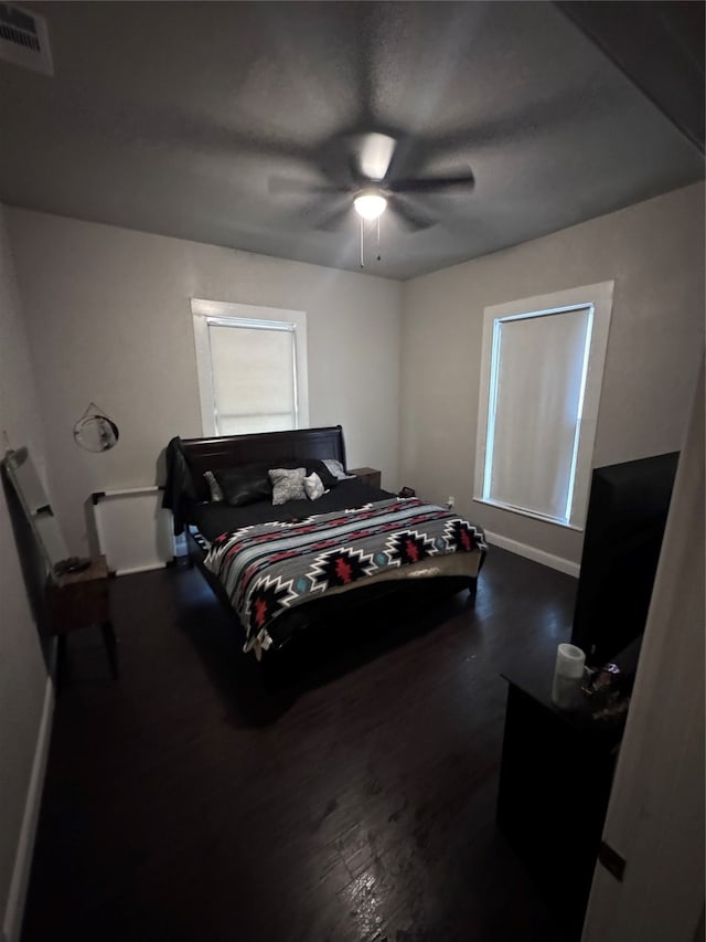 bedroom with ceiling fan and hardwood / wood-style flooring