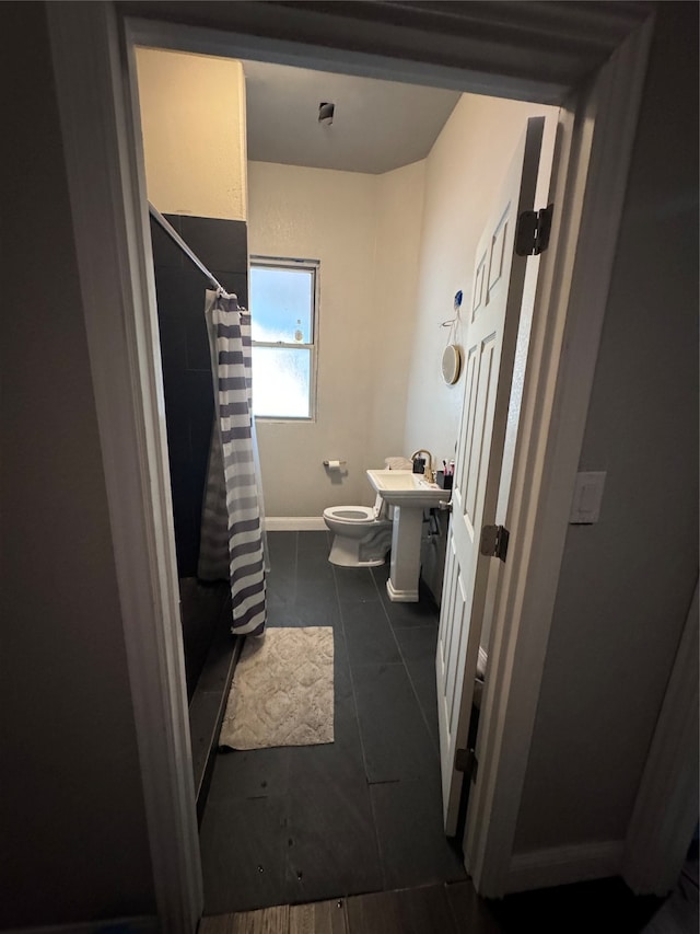 bathroom featuring vanity, toilet, a shower with curtain, and tile patterned floors