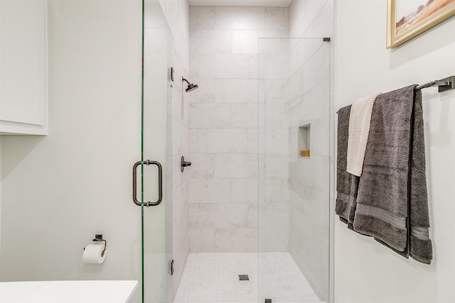 bathroom featuring a shower with door