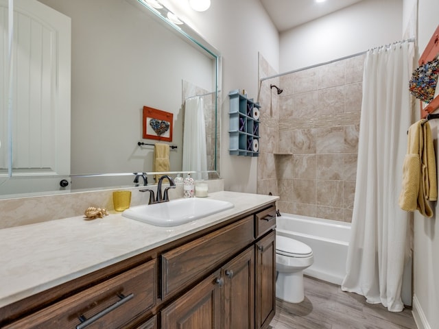 full bathroom with vanity, shower / bath combo, hardwood / wood-style flooring, and toilet