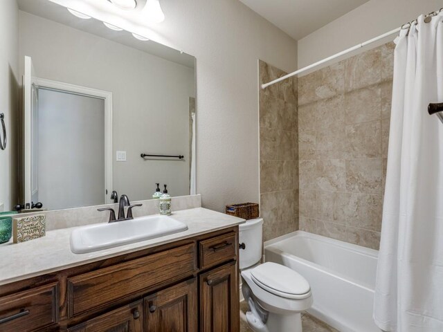 carpeted bedroom with ensuite bathroom and ceiling fan