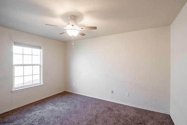 spare room featuring carpet flooring and ceiling fan