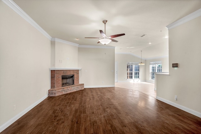 unfurnished living room with ceiling fan, wood-type flooring, ornamental molding, and a fireplace