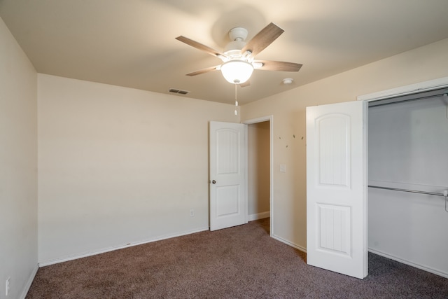 unfurnished bedroom with a closet, ceiling fan, and dark carpet