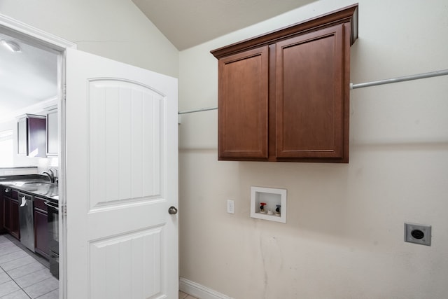 laundry room featuring hookup for a washing machine, hookup for an electric dryer, sink, cabinets, and light tile patterned floors