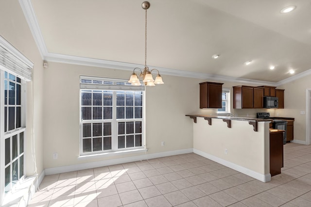 kitchen with ornamental molding, black appliances, hanging light fixtures, and a kitchen bar