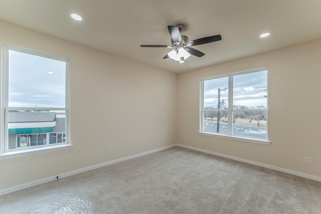 unfurnished room featuring ceiling fan and light carpet