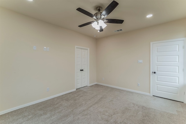 empty room featuring light carpet and ceiling fan