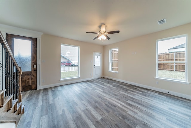 unfurnished living room featuring ceiling fan and wood-type flooring