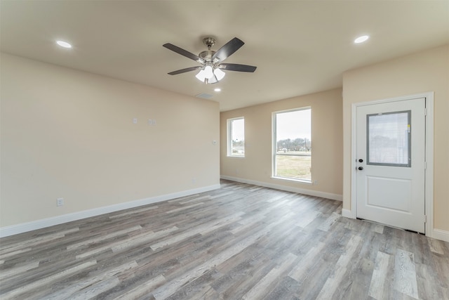 unfurnished room with ceiling fan and light wood-type flooring