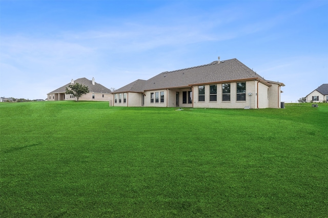 rear view of property featuring a yard