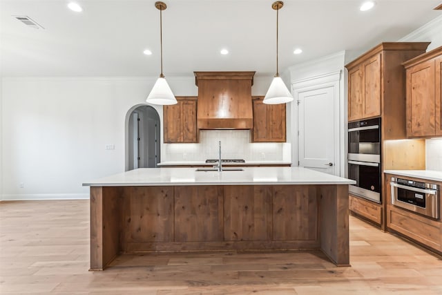 kitchen featuring arched walkways, appliances with stainless steel finishes, custom exhaust hood, and tasteful backsplash