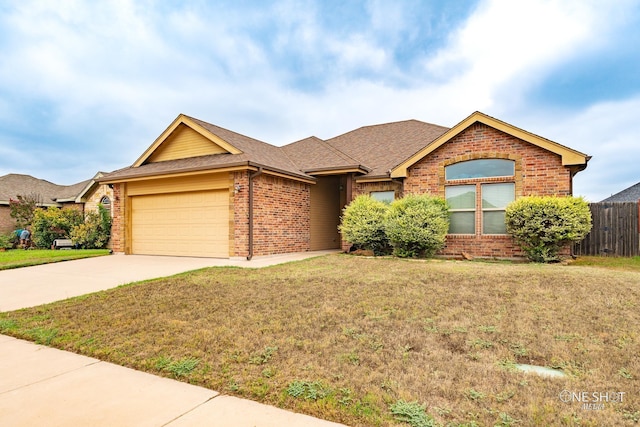 view of front of house featuring a front yard and a garage