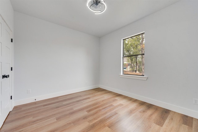 empty room featuring light wood-style flooring and baseboards