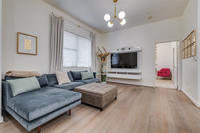 living room with a chandelier and light hardwood / wood-style floors