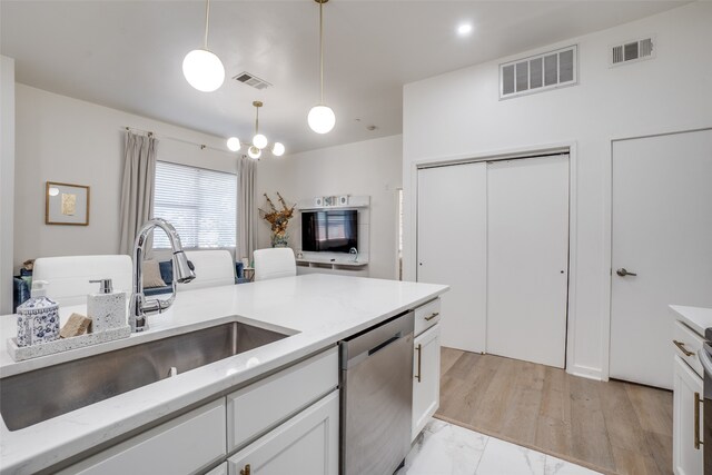 kitchen featuring light wood-type flooring, white cabinets, dishwasher, and sink