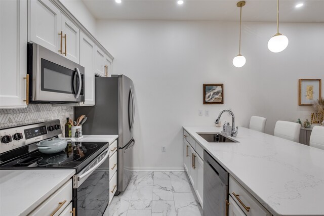 kitchen featuring backsplash, light stone counters, stainless steel appliances, sink, and pendant lighting