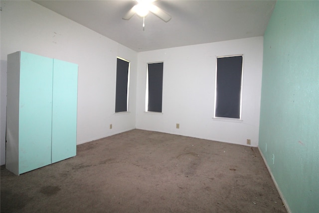 unfurnished bedroom featuring ceiling fan and carpet floors