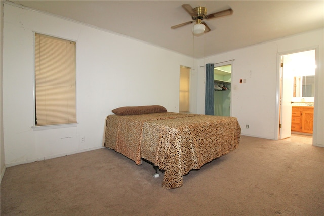 carpeted bedroom with connected bathroom and ceiling fan