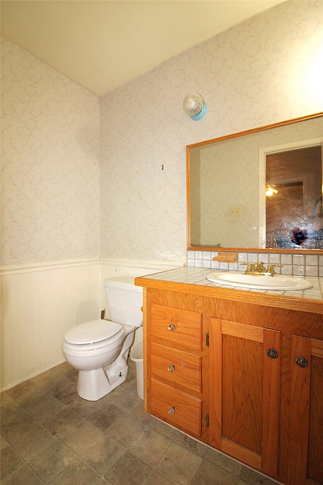 bathroom featuring toilet and vanity